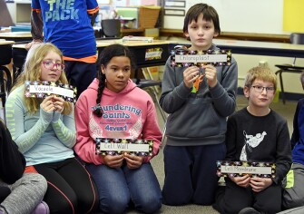Aubrey Langemo, left, Jayla Vaughn, Brayden Sund, and Joel Strang participate in a lesson on cell structure in Kathy Lentz’s 5th-grade biology class at Washington Elementary School.