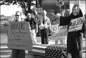 Teacher Pat Elder, in shirt and tie, demonstrates at a military recruiting station in Silver Spring, Md.