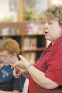 Cassandra Barnett, the librarian at Fayetteville High School in Arkansas, helps Advanced Placement Biology students learn how to write an abstract for their science fair projects. Ms. Barnett seeks to select library books that will intrigue, inform, challenge, and entertain the school’s 2,000 students.