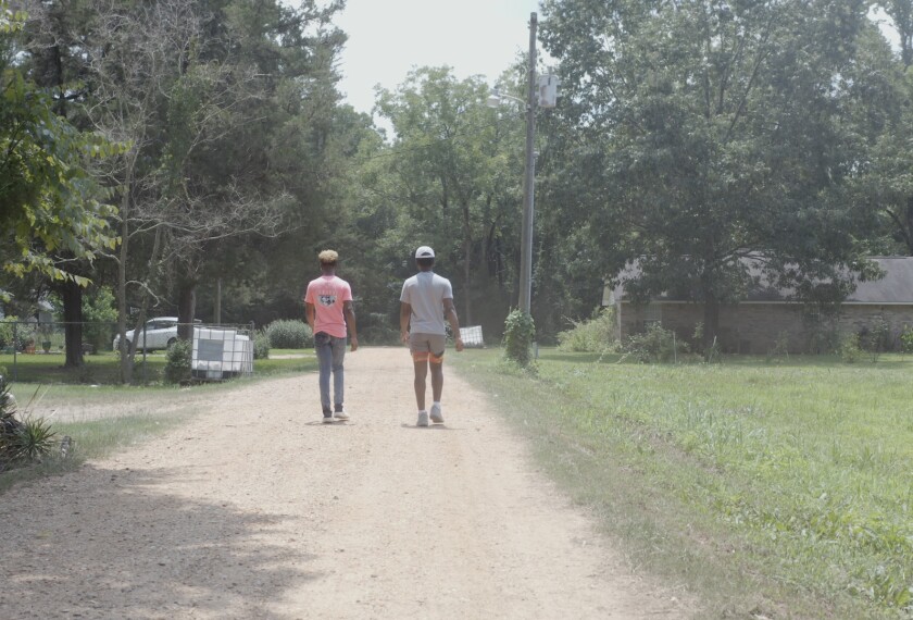 Twin brothers John and Jonathan Easter walk together in their hometown of Bradley, Ark. a few weeks before they are going to begin college on July 30, 2021.