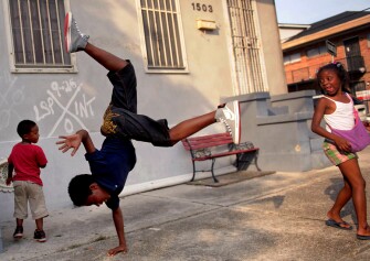 Desean Jefferson, 11, center, plays with his cousins Ja'Shawn Davis, 3, and Janiya Davis, 6, in front of their home in the Treme neighborhood in New Orleans, La. The children attended Holy Faith Temple Baptist Church summer camp where they made arts and crafts and played games. They had little else to do the rest of the summer in the neighborhood that still bears scars from Hurricane Katrina.