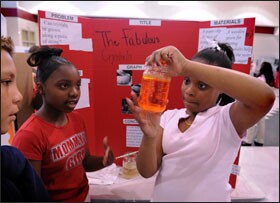Fifth graders Tamia Rucker, left, and Symone Brawner work on their crystals project for a science fair held in the New Holland cafeteria. Core Knowledge schools embrace a broad course of study to ensure that children are exposed to many topics.