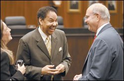 Assistant Education Secretary Henry L. Johnson, center, chats with consultant Paul Kimmelman at a House Education Reform Subcommittee hearing in Chicago last week.