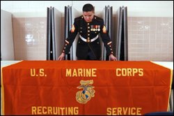 Sgt. Jose V. Morin of the U.S. Marine Corps sets up his recruiting table at Thomas A. Edison High School.