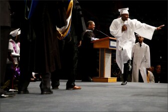 Joshua Johnson strides across the stage to receive his diploma as he graduates from Warren Easton Charter High School in New Orleans.