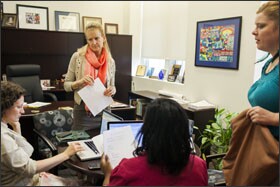 Principal Dawn Clemens, standing, meets with her assistant principals, Katie Franklin, left, and Tonya Harris, center, along with Stuart-Hobson's instructional coach, Sarah Hawley.
