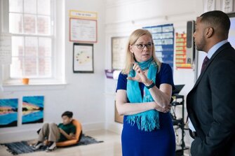 Principal Alethea Bustillo speaks with Instructional Superintendent Eric Bethel at Bruce Monroe Elementary School in Washington.