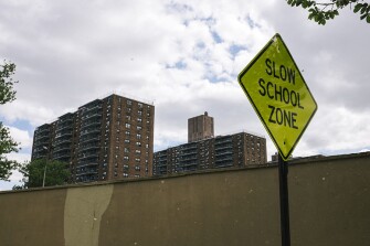 The Riverview Towers, a privately owned row of housing projects, looms over Paterson Public School 28, where the Paterson Academy for the Gifted and Talented is located in Paterson, N.J. The school is located in one of the city’s most crime-ridden and impoverished neighborhoods.