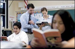 Student-teacher Pax Figioli confers with teacher Tina Ballabio in a 6th grade class at Sepulveda Middle School in California.