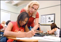 Teacher Janet Floyd answers a question for Frankie Hill as students in the Algebra 2 class review for their final exam. The Mount Pleasant district in Texas makes students take two-period courses in reading, math, and sciences if they failed those sections on the state test.