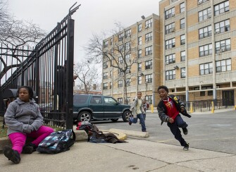 Children play outside Potomac Gardens. A program called Little Lights Urban Ministries works with children in the housing development, providing tutoring, mentoring, and after-school support. Several residents also volunteer with the program, which is an example of community supports that have developed around traditional public housing complexes.