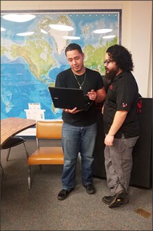 Brandon Velazquez, left, works after class with Carlos Munoz, an instructor and advisor at Eastern Washington University. Velasquez credits a transition course he took as a high school senior with helping him succeed in college. “I was a little worried when I first got here, but everything’s coming pretty easy to me,” he says.