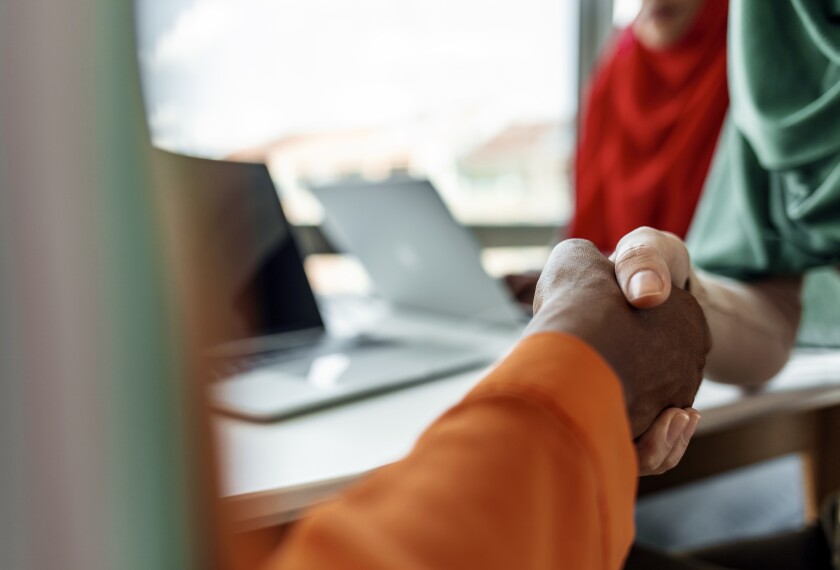 Photo of people shaking hands.