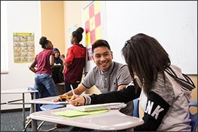 Northfield freshman Moises Ramirez jokes with a classmate during a French class group activity. A new class of 200 students is signed up to enroll next school year.