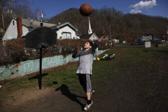 Dakota Waldron, 11, a 6th grader at Mountain View Middle School, plays basketball after school at his home in McDowell County.