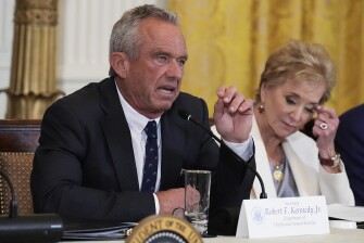 Health and Human Services Secretary Robert F. Kennedy Jr. speaks as Education Secretary Linda McMahon listens during a Make America Healthy Again (MAHA) Commission Event in the East Room of the White House on May 22, 2025, in Washington.