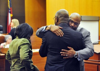 Fulton County Senior Assistant District Attorney Clint Rucker, right, hugs Fulton County District Attorney Paul Howard after a jury read guilty verdicts for 11 defendants in the test-cheating trial.