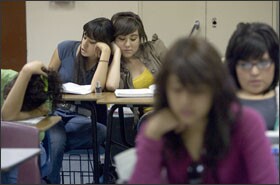 Andrea Sanchez, left, reads an English exercise out loud while leaning against Diane Medina during an English-language-development class at Nogales High School.