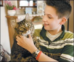 Kristin Langner, playing with her cat Wolfgang, says that even after being outed by other students as a lesbian, she felt generally accepted at Don Bosco High School, a Roman Catholic school in Gilbertville, Iowa. She is now a freshman at the University of Northern Iowa.