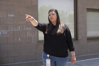 Angela Alfaro, a paraprofessional at Pascual LeDoux Academy, helps instruct a student on cleaning up outside on Thursday, June 2, 2022 at Pascual LeDoux Academy in Denver.