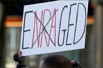 A sign protesting the National Rifle Association is held overhead during the March for Our Lives rally in Pittsburgh last year.