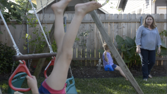 Carrie Fisher keeps a close eye on daughter Laura, 6, at far left, and son Charles, 4, as they play in the backyard of their New Orleans home.