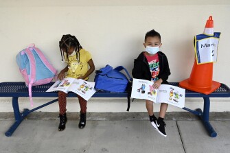 Students wait for their teacher on the first day of school at the Normont Early Education Center in Harbor City, Calif., on Monday, Aug. 16, 2021.