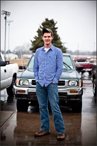 Student Clynt Goins, 17, stands in front of his truck at McMinn County High School in Athens, Tenn. The state suspended the high school senior's driver's license last year because of truancy and poor grades, but he stepped up his focus on school to get it back. Mr. Goins now credits Tennessee's driver's-license law with keeping him on track to graduate this year.