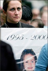 Robin Stavola of Colts Neck, N.J., protests at the Statehouse last month holding a photo of her daughter Holly, whose death she believes was caused by a vaccine.