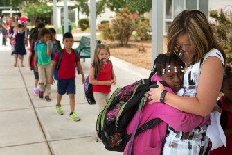 Janna Sells hugs 3rd grade student Shamonica Branch at the end of the school day at East Iredell.