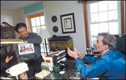 Haruto Yoshii, the director of a home-school support group in Tokyo, left, shows Christopher J. Klicka, a U.S.-based advocate for home schooling, a photo of home-schooled Japanese students at Mr. Klicka's Virginia home last month.