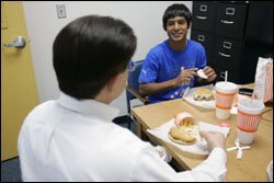 Engineer Robert J. LeBlanc meets with Chris Osorio, a high school sophomore he mentors. Though youth-mentoring programs have taken off, the research base has yet to catch up.