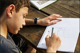 Justin Barreras, 10, works on science schoolwork before soccer practice.