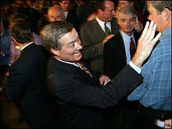 Colorado Gov. Bill Owens waves to well-wishers as he works his way through the crowd at a Nov. 1 victory rally in Denver for a referendum that suspends a restrictive state spending formula.