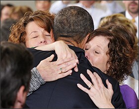 The president embraces Jane Dougherty, right, and Sue Connors, sisters of slain Sandy Hook Elementary School psychologist Mary Sherlach.