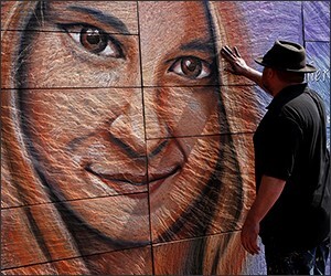 Artist Sam Welty creates a mural of Heather Heyer, who was killed while protesting a white nationalist rally in Charlottesville, Va., on August 12, 2017.