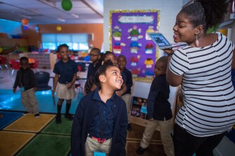 Kindergartner Ava Josephine Mikel and teacher Priscilla Joseph dance to Haitian music during a game of “freeze dance” at Toussaint L’Ouverture Academy, a Haitian Creole dual-language program at Mattahunt Elementary School in Boston. More dual-language programs are cropping up in districts around the country.