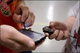One of the school’s teachers uses a hand-held digital device to record heartrate information collected in students’ watches.