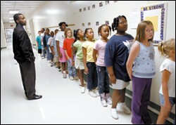 Hayward Jean watches the orderly return of students after lunch.