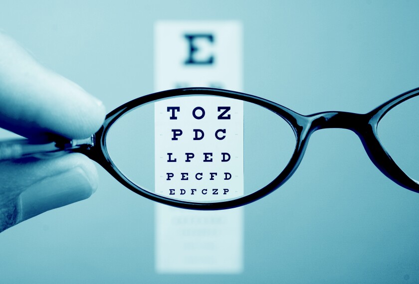 Image of eyeglasses and an eye examine chart with letters.