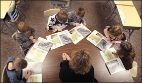 First grade students at Lynnville-Sully Elementary School in Sully, Iowa, take part in a guided reading lesson with teacher Jennifer Rozendaal.