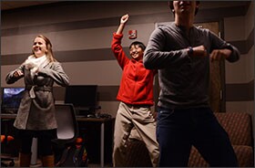 Clemson University undergraduate Mary Pat Kiser, left, Ph.D. student Lorraine Lin, and undergraduate Emerson Smith take part in a dance video game in Clemson University's Digital Media and Learning Lab, a space designed to foster participation and stimulate thinking about the role of digital tools in the classroom.