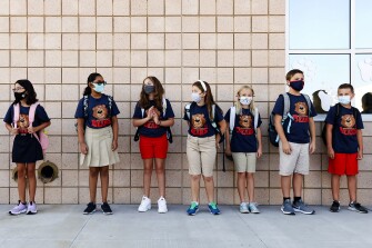 Student ambassadors line up for the ribbon cutting ceremony and first day of school at the new Hannah Marie Brown Elementary School in Henderson, Nev., Monday, Aug. 9, 2021. Doors opened Monday at schools in and around Las Vegas, where masks were required for the more than 300,000 students and about 18,000 teachers returning to in-person classes at the fifth-largest district in the nation.