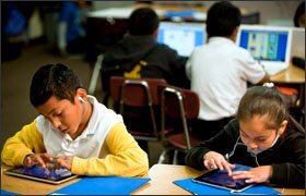 Christian Navarro and Daily Mora Gomez, in Robert Provonost's 2nd grade class, record original stories into their iPads during centers time.