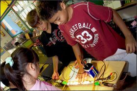 Sixth graders at Waikiki Elementary School in Honolulu show off and explain their green science projects to other students this month.