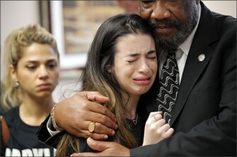 Aria Siccone, 14, a 9th grade student survivor from Marjory Stoneman Douglas High School, is embraced by state Rep. Barrinton Russell as she recounts her story from that day. Students from the school rallied at the state capitol on Feb. 21, in Tallahassee, Fla., and spoke to legislators pressing their case for increased gun control legislation.