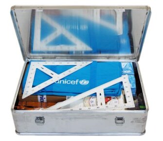 Weighing about 115 pounds, the aluminum box contains classroom materials, including the ones pictured here, for up to 80 children. It's lid can be painted with the enclosed brush and black paint, allowing it to double as a chalkboard.