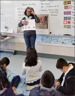 Michele Haussler, a parent and Art in Action volunteer, teaches 5th graders at Taft Community School in Redwood City, Calif., about the quilts created to pass on signals to fleeing slaves traveling on the Underground Railroad.