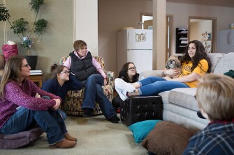 From left, intern therapist Kelly Johnson, student Latavia, 16, youth service specialist Megan Peak, and students Emily, 15, and Marisa, 17, gather together for art therapy in a dorm.