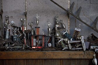 Trophies sit in a destroyed display case inside the old Joplin High School.